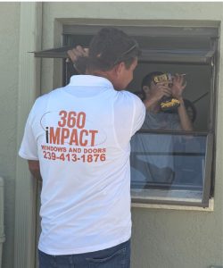 360 iMPACT technician installing an impact window during a home improvement project in Florida